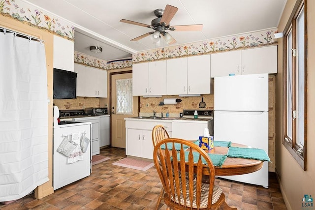 11 Aiken Crk, Silver Bay, MN 55614 - kitchen with freestanding refrigerator, decorative backsplash, a ceiling fan, and white cabinets