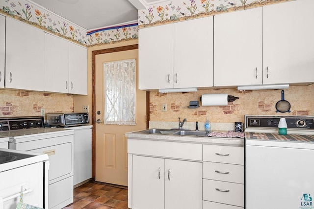 11 Aiken Crk, Silver Bay, MN 55614 - kitchen with a sink, backsplash, light countertops, white cabinetry, and washer and dryer