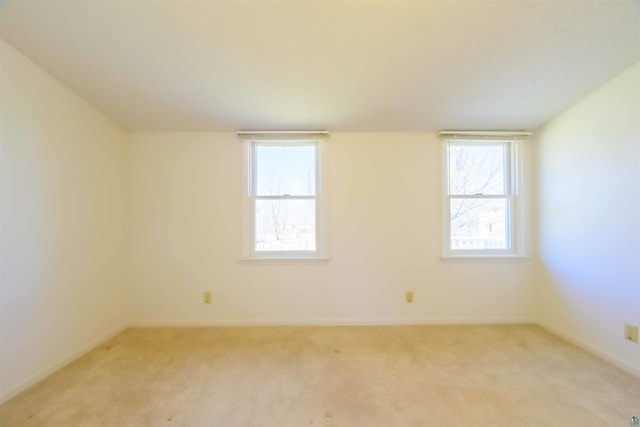 335 E Willow St, Duluth, MN 55811 - empty room featuring light colored carpet, healthy amount of natural light, and baseboards