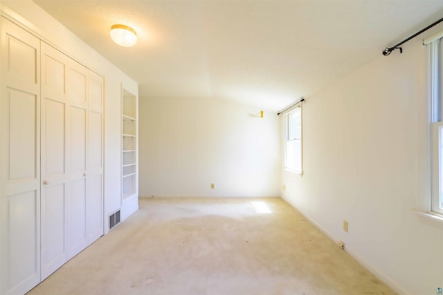 335 E Willow St, Duluth, MN 55811 - unfurnished bedroom featuring light colored carpet, a closet, and lofted ceiling