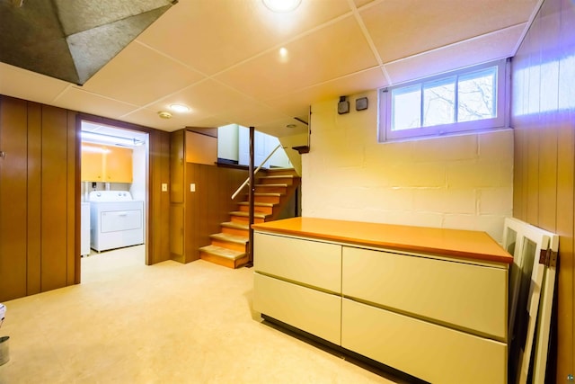 335 E Willow St, Duluth, MN 55811 - below grade area featuring stairway, separate washer and dryer, concrete block wall, light carpet, and a paneled ceiling