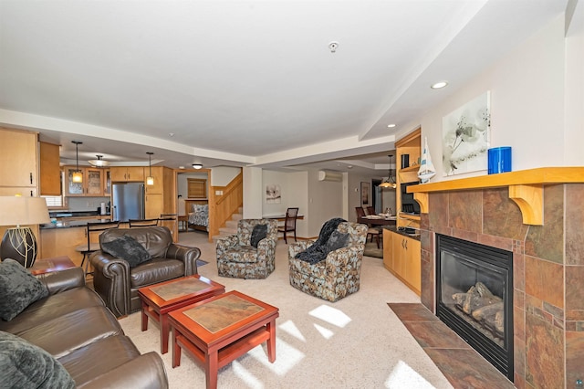 2126 Water St Unit L306, Duluth, MN 55812 - living room featuring stairway, a tile fireplace, recessed lighting, a wall unit AC, and light carpet