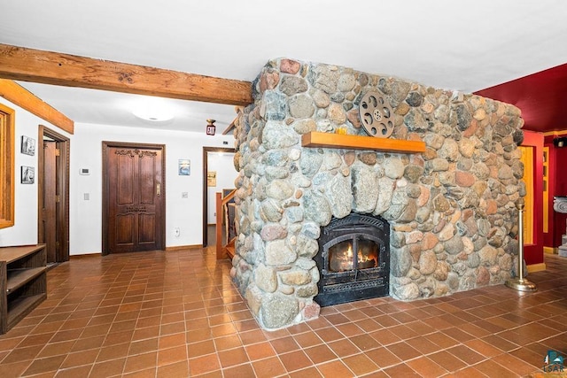 4015 E Van Rd, Duluth, MN 55803 - unfurnished living room featuring tile patterned flooring, baseboards, beamed ceiling, and a stone fireplace