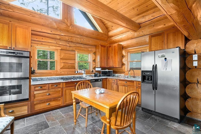 4015 E Van Rd, Duluth, MN 55803 - kitchen with appliances with stainless steel finishes, a sink, brown cabinets, wooden ceiling, and stone tile flooring