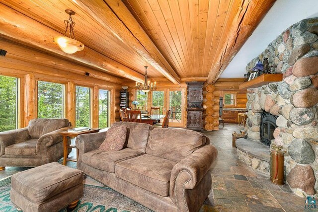 4015 E Van Rd, Duluth, MN 55803 - living room featuring log walls, wood ceiling with exposed beams, stone tile floors, a chandelier, and a stone fireplace