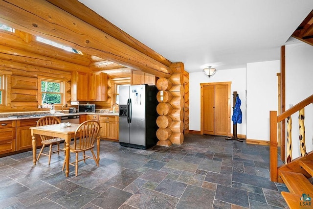 4015 E Van Rd, Duluth, MN 55803 - kitchen featuring stainless steel appliances, rustic walls, light countertops, a sink, and baseboards