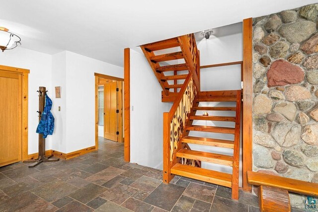 4015 E Van Rd, Duluth, MN 55803 - stairway featuring baseboards and stone finish flooring