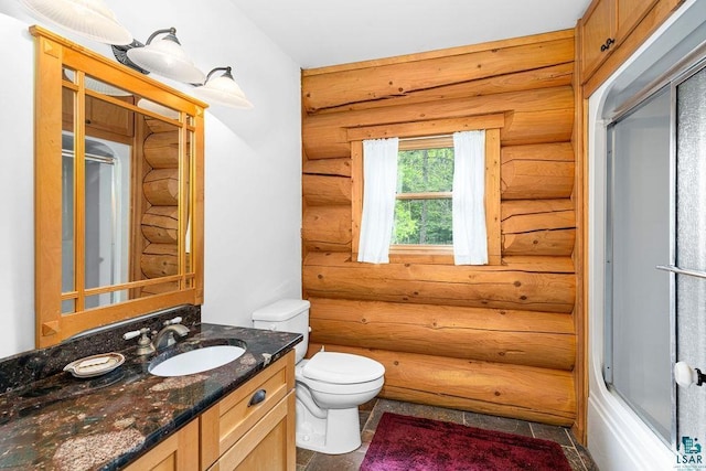 4015 E Van Rd, Duluth, MN 55803 - full bathroom with rustic walls, toilet, vanity, and a shower with door