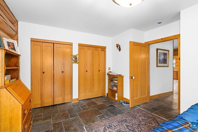 4015 E Van Rd, Duluth, MN 55803 - unfurnished bedroom with two closets, stone tile floors, and baseboards