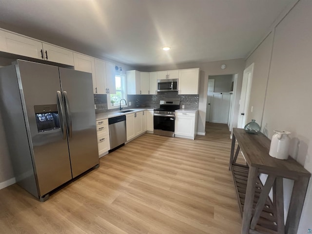 10 Canosia Rd, Esko, MN 55733 - kitchen with appliances with stainless steel finishes, a sink, white cabinets, light countertops, and light wood-style floors