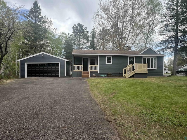 10 Canosia Rd, Esko, MN 55733 - view of front of home with a detached garage, an outbuilding, a front yard, a porch, and a chimney