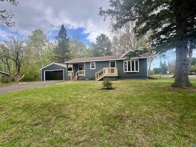 10 Canosia Rd, Esko, MN 55733 - single story home with an outbuilding, a detached garage, and a front lawn
