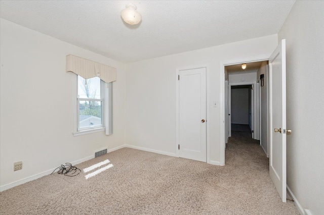 5526 W 8th St, Duluth, MN 55807 - carpeted spare room with baseboards and a textured ceiling