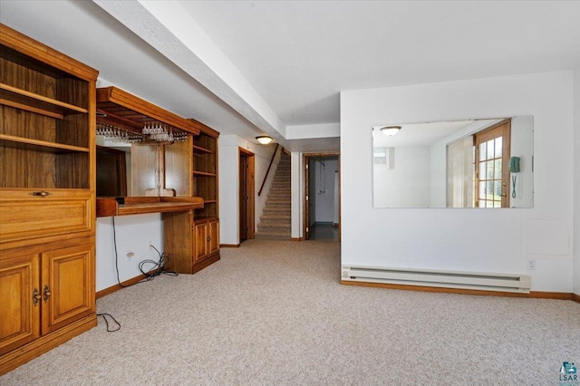 5526 W 8th St, Duluth, MN 55807 - spare room featuring a baseboard heating unit, light carpet, baseboards, and stairway