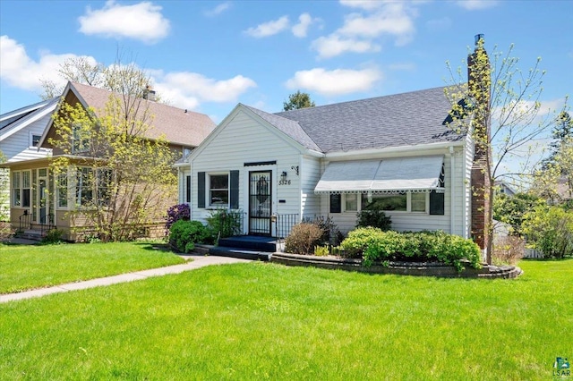 5526 W 8th St, Duluth, MN 55807 - bungalow-style home with a chimney, a front yard, and roof with shingles