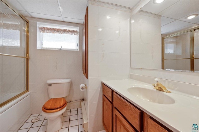 5526 W 8th St, Duluth, MN 55807 - full bathroom featuring toilet, vanity, tile walls, tile patterned flooring, and combined bath / shower with glass door