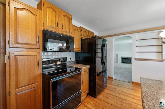 5526 W 8th St, Duluth, MN 55807 - kitchen featuring black appliances, arched walkways, light countertops, and light wood-style floors