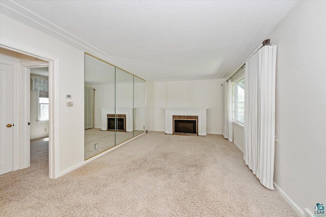 5526 W 8th St, Duluth, MN 55807 - unfurnished living room featuring a fireplace with flush hearth, carpet flooring, and plenty of natural light