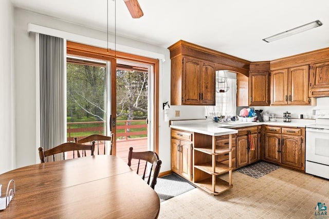 2611 Chambersburg Ave, Duluth, MN 55811 - kitchen featuring electric range, light countertops, open shelves, and brown cabinetry