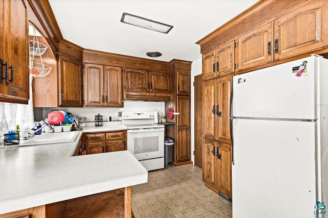 2611 Chambersburg Ave, Duluth, MN 55811 - kitchen featuring white appliances, a sink, light flooring, light countertops, and brown cabinets