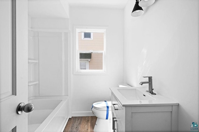 4124 Gilliat St, Duluth, MN 55804 - full bath with vanity, toilet, wood finished floors, shower / bath combination, and baseboards