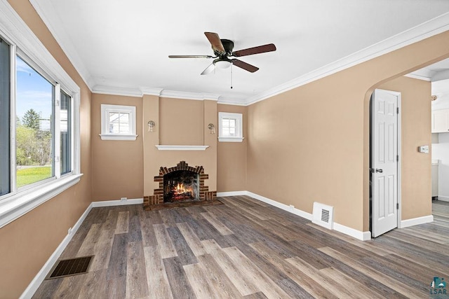 4124 Gilliat St, Duluth, MN 55804 - unfurnished living room featuring wood finished floors, healthy amount of natural light, baseboards, and crown molding