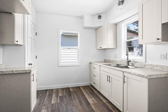 4124 Gilliat St, Duluth, MN 55804 - kitchen with a sink, dark wood finished floors, light countertops, and baseboards