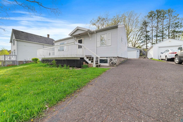 2229 Hillcrest Dr, Duluth, MN 55811 - back of house with a garage, a wooden deck, a lawn, and an outbuilding