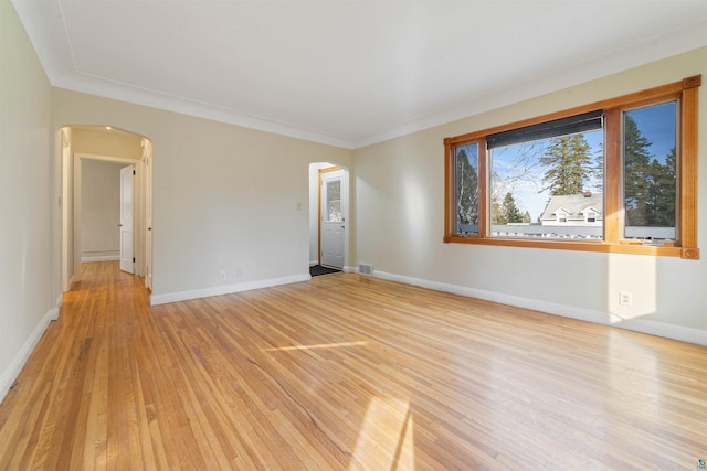 2229 Hillcrest Dr, Duluth, MN 55811 - unfurnished room featuring arched walkways, light wood-type flooring, baseboards, and crown molding
