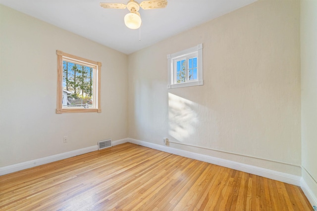 2229 Hillcrest Dr, Duluth, MN 55811 - unfurnished room with healthy amount of natural light, baseboards, light wood finished floors, and a ceiling fan