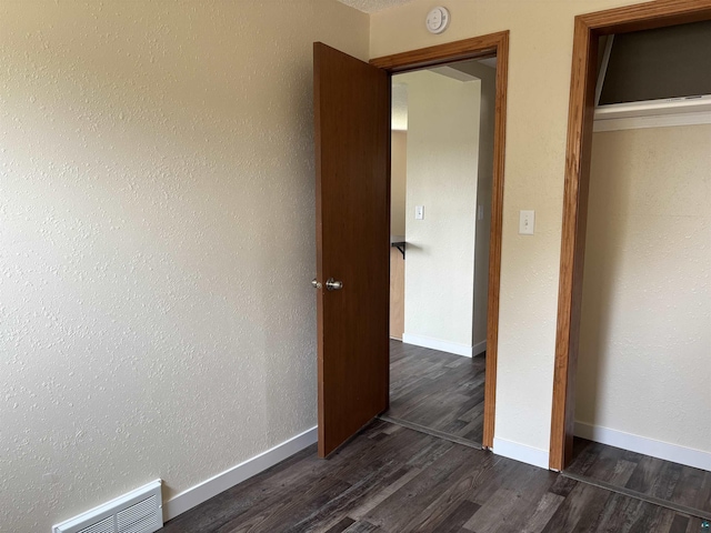 408 Midway Ave, Proctor, MN 55810 - unfurnished bedroom with dark wood-style floors and baseboards