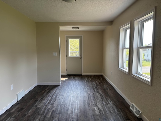408 Midway Ave, Proctor, MN 55810 - unfurnished room with dark wood-style flooring, baseboards, and a textured ceiling