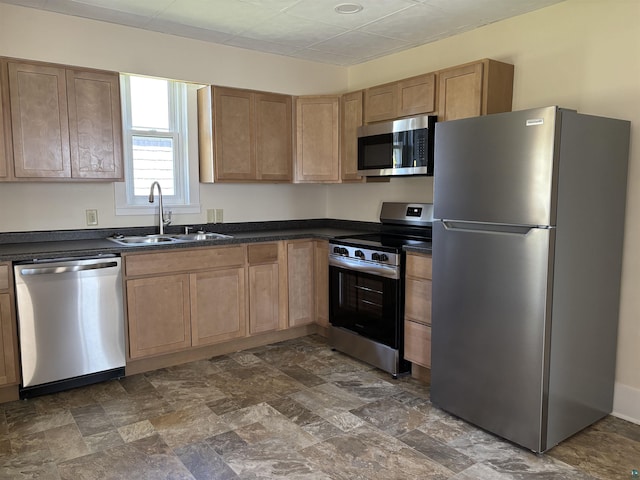 132 1st St, Proctor, MN 55801 - kitchen with stainless steel appliances, a sink, dark countertops, and dark stone finish floors