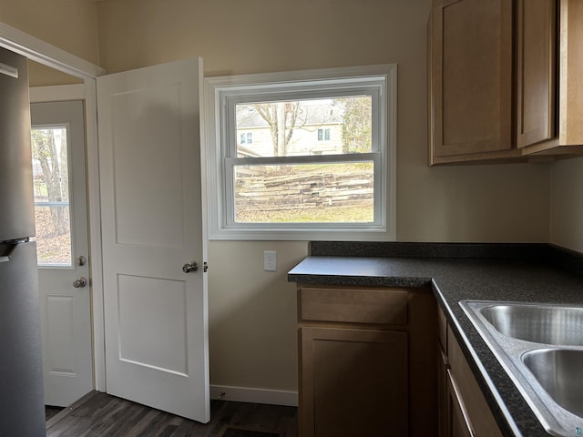 1417 N 7th Ave E, Duluth, MN 55805 - kitchen featuring dark countertops, dark wood-style floors, freestanding refrigerator, and baseboards