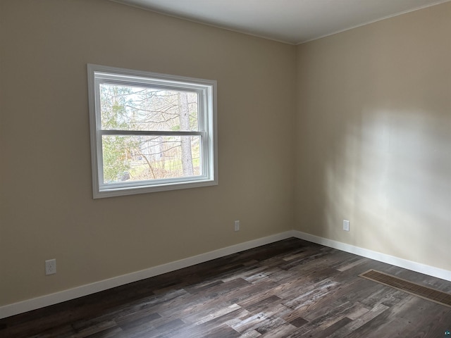 1417 N 7th Ave E, Duluth, MN 55805 - spare room featuring dark wood-style flooring, baseboards, and crown molding