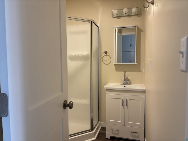 1417 N 7th Ave E, Duluth, MN 55805 - bathroom featuring a shower stall, vanity, and wood finished floors