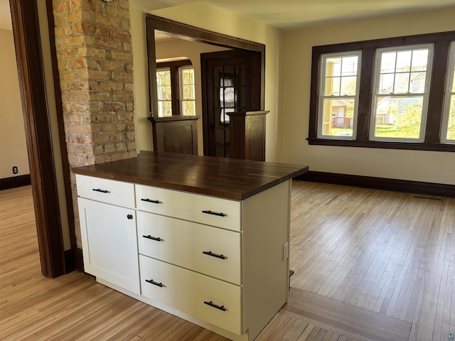620 N 40th Ave W, Duluth, MN 55807 - kitchen with butcher block counters, light wood-style floors, baseboards, and white cabinetry