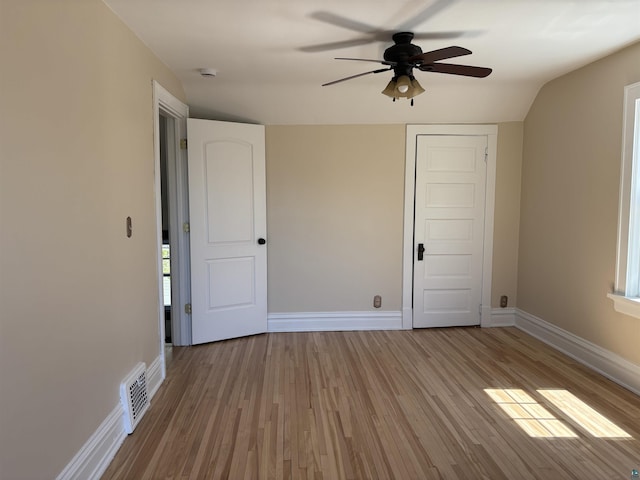 620 N 40th Ave W, Duluth, MN 55807 - unfurnished bedroom featuring wood finished floors, baseboards, ceiling fan, lofted ceiling, and a closet