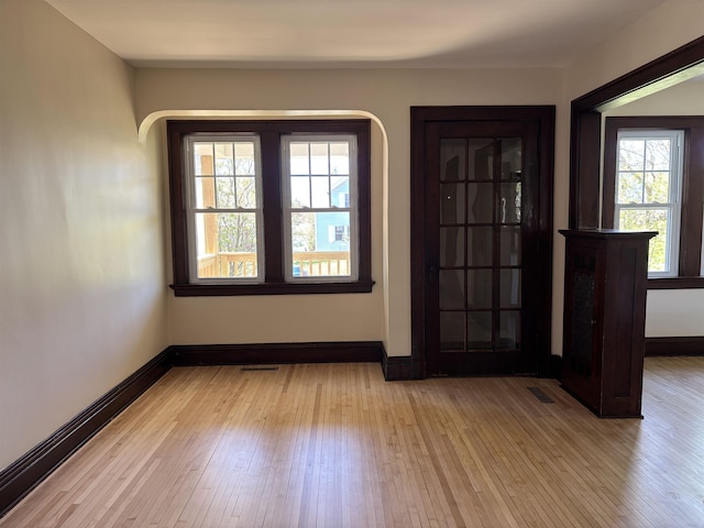 620 N 40th Ave W, Duluth, MN 55807 - foyer entrance featuring light wood finished floors, plenty of natural light, baseboards, and arched walkways