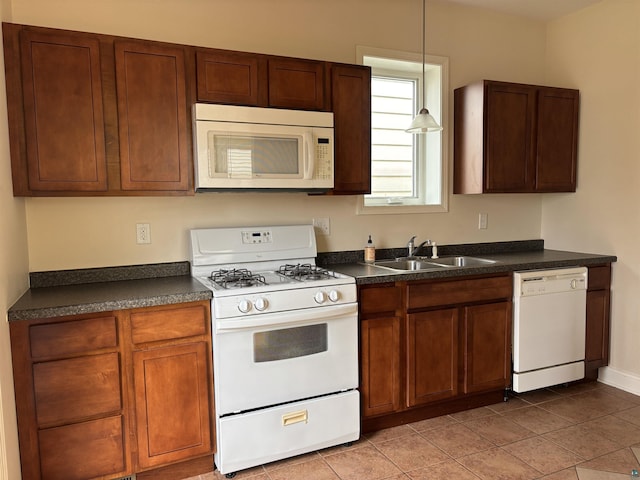 819 N 10th Ave E, Duluth, MN 55805 - kitchen with white appliances, dark countertops, a sink, and pendant lighting