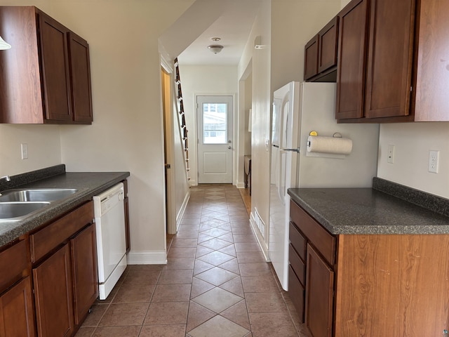 819 N 10th Ave E, Duluth, MN 55805 - kitchen featuring dishwasher, dark countertops, tile patterned flooring, and a sink