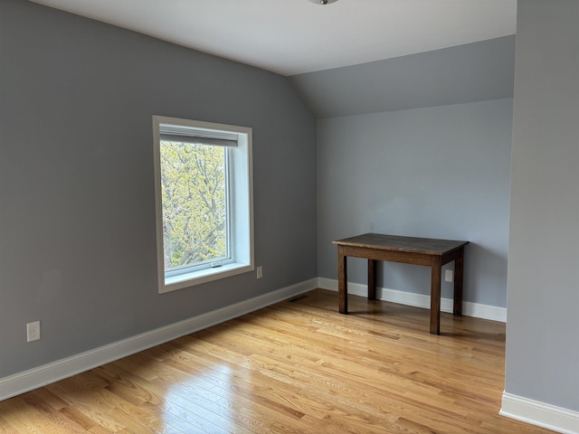 819 N 10th Ave E, Duluth, MN 55805 - empty room with light wood finished floors, lofted ceiling, and baseboards