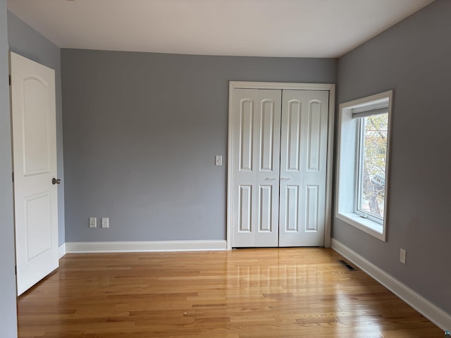 819 N 10th Ave E, Duluth, MN 55805 - unfurnished bedroom with light wood finished floors, baseboards, and a closet
