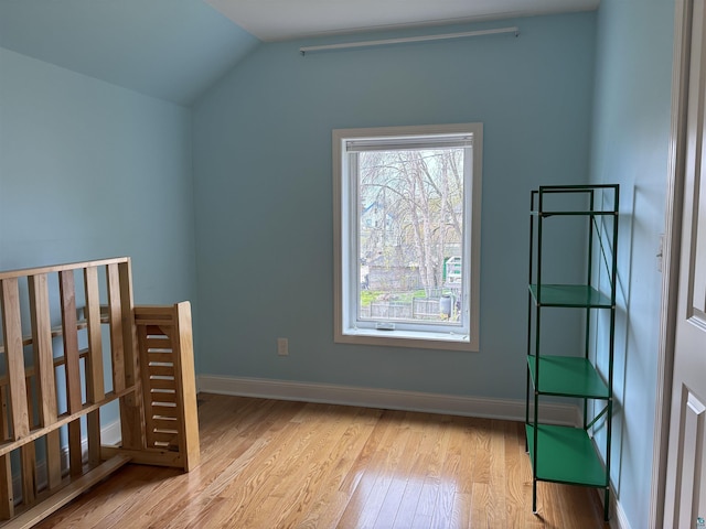 819 N 10th Ave E, Duluth, MN 55805 - unfurnished bedroom with wood finished floors, vaulted ceiling, and baseboards
