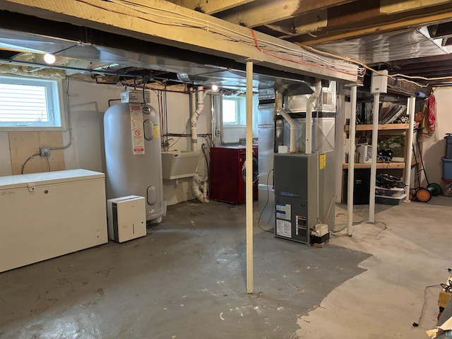 819 N 10th Ave E, Duluth, MN 55805 - basement with water heater, fridge, heating unit, and plenty of natural light