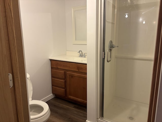 819 N 10th Ave E, Duluth, MN 55805 - full bath featuring a stall shower, toilet, wood finished floors, vanity, and baseboards