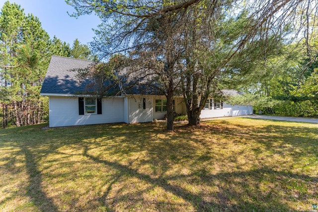 11 Ahola Rd, Ely, MN 55731 - view of front facade featuring roof with shingles and a front lawn