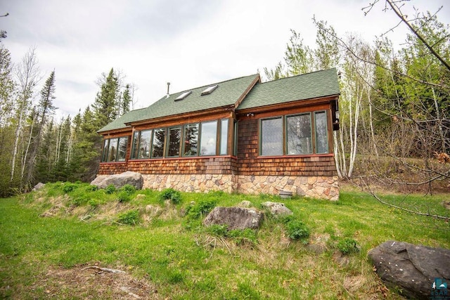 258 Soderberg Ln, Grand Marais, MN 55604 - view of side of property featuring roof with shingles