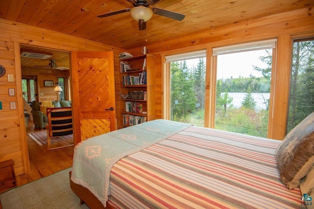 258 Soderberg Ln, Grand Marais, MN 55604 - bedroom featuring wood walls, wood finished floors, and a water view