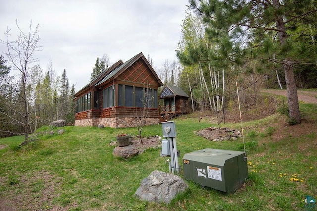 258 Soderberg Ln, Grand Marais, MN 55604 - back of house featuring a sunroom and a yard